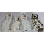 A pair of Staffordshire fireside spaniels, together with two other various fireside spaniels