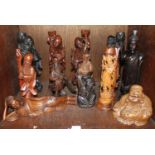 SECTION 38. A quantity of Oriental wooden carved figures including a laughing Buddha, warriors and