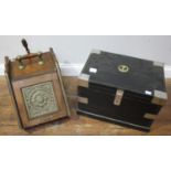 A small black painted pine trunk with metal strap work and applied brass naval crest to top and a