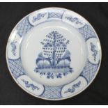 An 18th Century English Delft pottery charger, the centre decorated with a tree, the flange rim with
