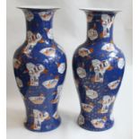 A large pair of modern Chinese porcelain floor vases, of baluster form with flared rims, painted