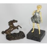 A small bronze figure of a rearing horse, on naturalistic base, 12 cm high, together with an Art