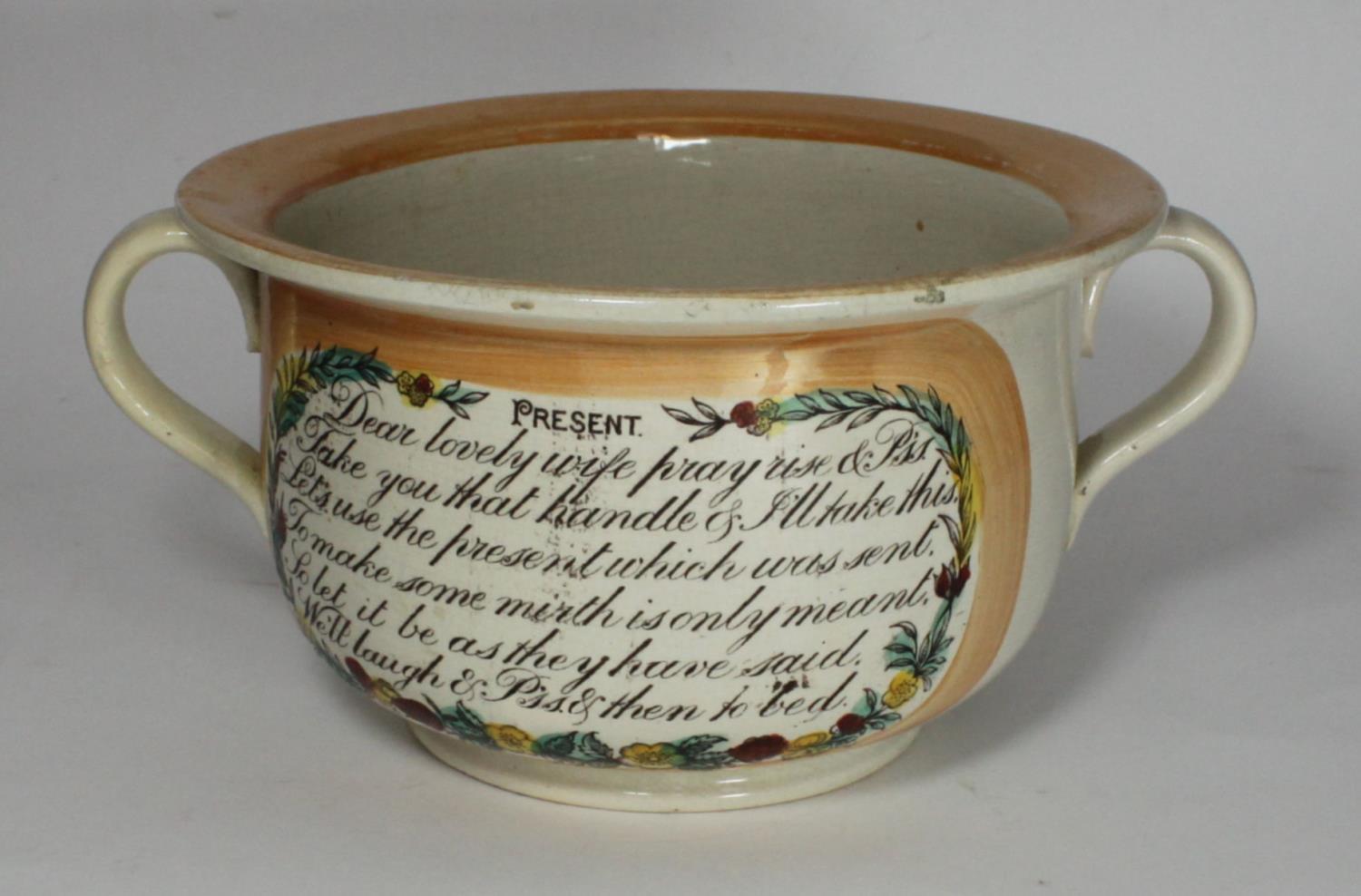 A 19th century Sunderland lustre chamber pot, the sides decorated with prose to a yellow lustre