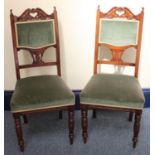 A pair of stained standard chairs, the carved backs with leaf moulded decoration, pierced love