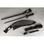 M1886 Lebel bayonet with cruciform blade and metal scabbard, together with a Nepalese Kukri knife, a