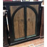 An Indian hardwood two-door store cupboard, 18th century arch carved and painted distressed doors