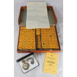 A cased Mahjong set by 'Jackpot', with tiles, rule-book and a cased set of stands etc. together with