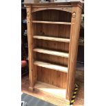 Three various pine bookcases with shaped cornice and dentil moulding, carved floral decoration,