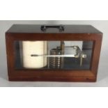 An aneroid barograph, in hinged and glazed walnut case, 28cm wide