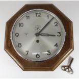 A wall mounted Kriegsmarine wardroom clock, the circular silvered dial with Arabic numerals denoting