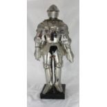 A modern figure of a medieval knight in armour, on plinth base, 68cm high