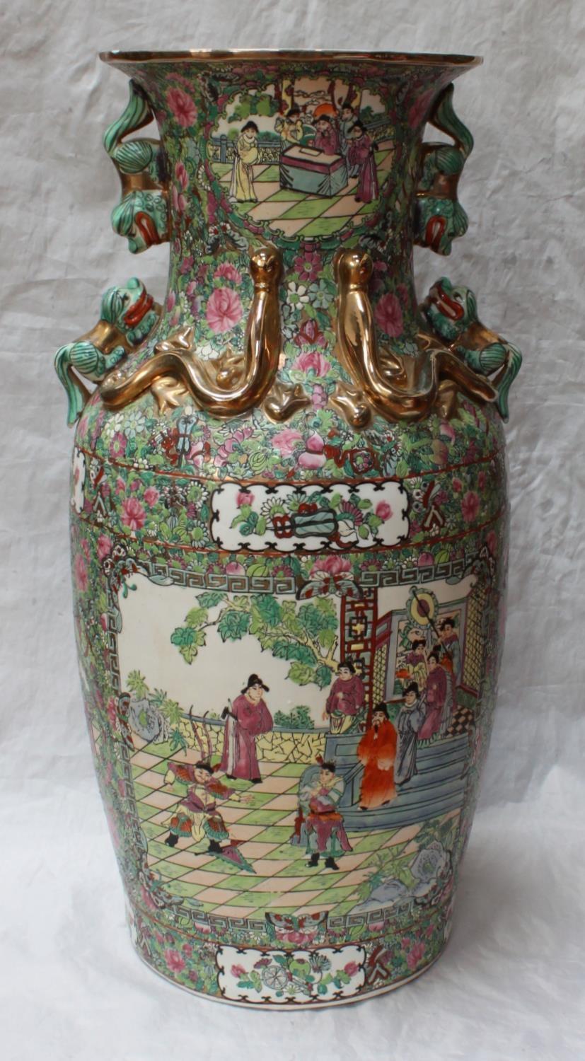 An early 20th century Chinese Canton enamel baluster vase, the sides with panels depicting