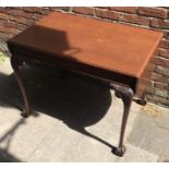 A mahogany drop-leaf supper table raised on carved cabriole supports to claw and ball feet,