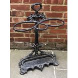 A 1920s Coalbrookdale style cast iron umbrella stand decorated with fruiting vines, masks and