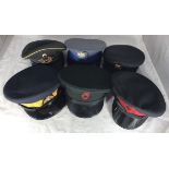 Six various peaked caps including Royal Canadian Mounted Police, German cap by Bamberger, Northern