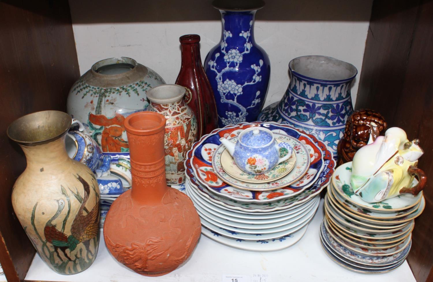 SECTION 15. A collection of assorted oriental ceramics including various vases, an ornamental Foo