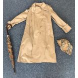 A ladies vintage Burberry trench coat in beige, with traditional collar, epaulettes, belt and
