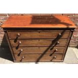 A Victorian mahogany chest of four long drawers with turned knobs, top drawer with compartmented