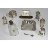 A small collection of assorted silver items comprising an ashtray, salts and pepper etc. together