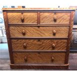 A satinwood chest of two short, over three long graduated drawers with turned pulls, raised on