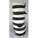 Six Naval white caps with tallies for HMS Sultan, HMS Mercury, HMS Raleigh, HMS Collingwood, HMS