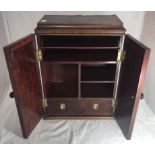 An inlaid mahogany desk-top stationery cupboard, a pair of doors with turned knobs opening to reveal