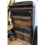 A 1920s stained oak Globe Wernicke 'style' seven-section stacking bookcase, with cupboard base and