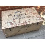 A large painted flat-topped camphor wood travelling trunk with twin handles, printed to the cover