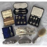 A small collection of assorted cased silver flatware comprising two sets of coffee spoons, forks and
