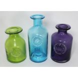 Three various Dartington Glass coloured bottles of varying sizes and colours, 25cm high