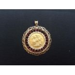 A Geo. V gold Sovereign, 1918, Sydney MM, in 9ct gold circular necklace pendant set with 24x round