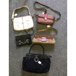 A Black vintage Gucci zip top handbag with a Gold buckle, Gucci print, inside pocket and black