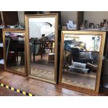 Three assorted rectangular gilt framed mirrors, two with bevelled glass, largest measures 131 x 71cm