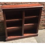 A reproduction mahogany and satinwood inlaid adjustable open bookcase with three fluted columns,