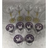 A set of six Art Deco cocktail glasses decorated with swags to plum coloured ground, together with a