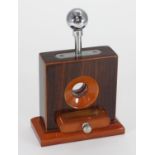 A rosewood effect desktop cigar cutter, with chrome lever to operate guillotine and removable