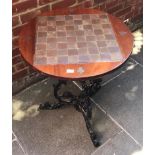 A mahogany and inlaid copper circular games table, raised on black painted cast iron ornate