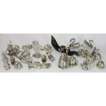 A collection of assorted silver-plated cruet sets including one modelled as a branch, swan shaped