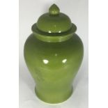 A large Chinese temple vase and cover, glazed in pea green, approx. 44cm high