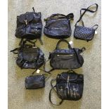 A selection of ladies Black leather bags, including a Guess rucksack with front pockets and silver