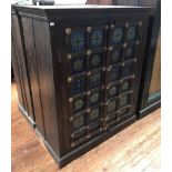 An Indian hardwood two-door cupboard, 19th century carved doors inset with floral tiles and brass