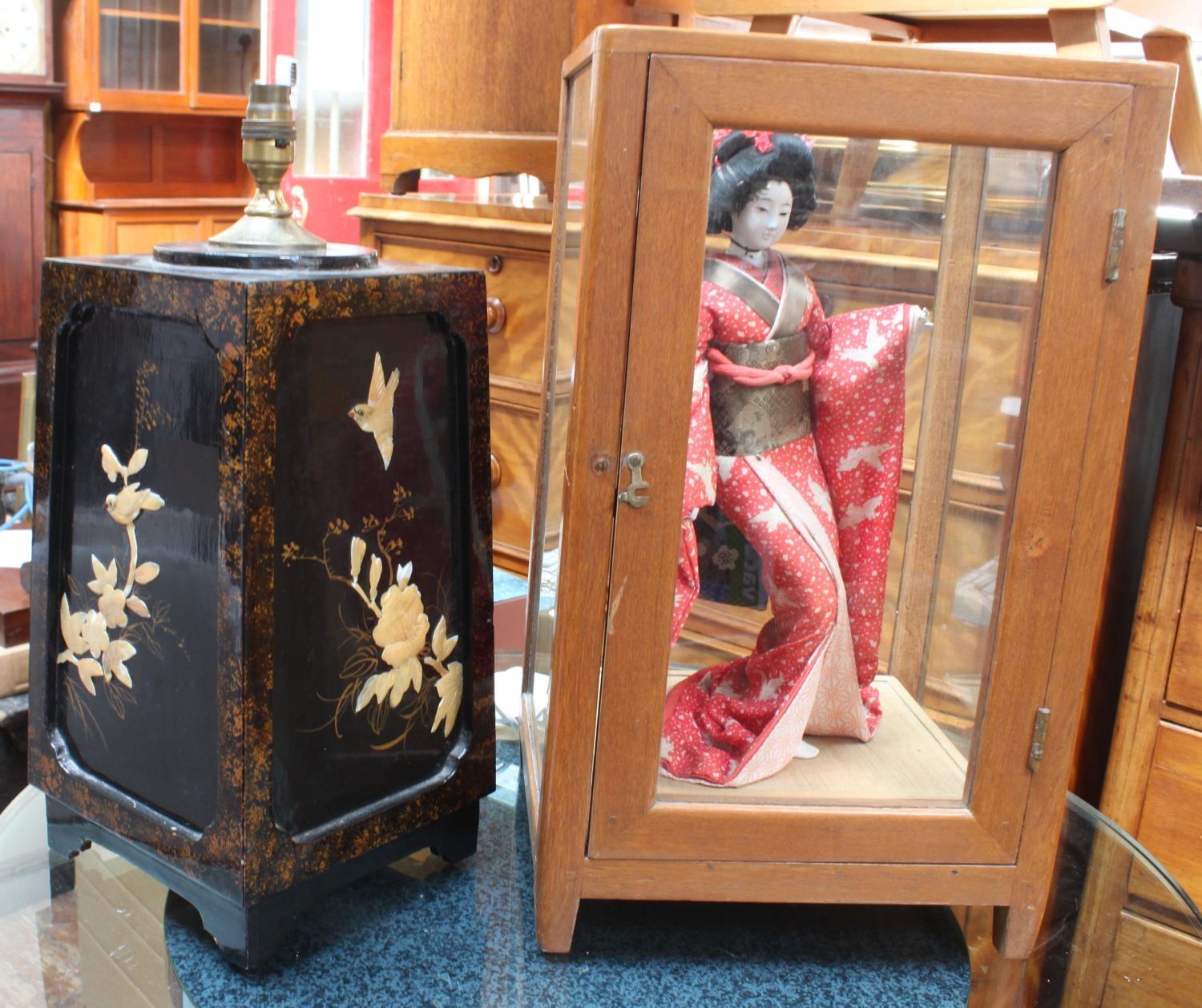 A Japanese Geisha Girl standing doll in separate glazed walnut cabinet, 52cm high, together with a