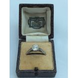 A lady's unhallmarked Platinum solitaire diamond ring. Diamond is claw set with 6x eight cut