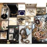 A large selection of assorted costume jewellery including beads, brooches, watches and cufflinks