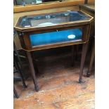 An Edwardian mahogany octagonal bijouterie table, with lockable, hinged glass top and glazed