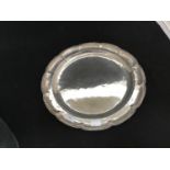 A continental .900 grade silver salver, of plain design and with shaped rim, 39cm diameter, gross