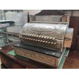 A large American chrome National cash register with heavily embossed decoration, keys working but