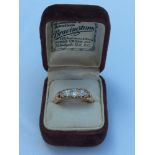 A lady's 18ct yellow gold victorian cut diamond ring, set with five diamonds in a gallery setting.