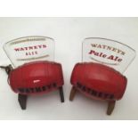 Two Watneys red plastic barrel illuminating bar advertising signs, raised on wooden stands, 22 x