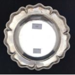 A small continental .900 grade silver salver, of plain design and with shaped rim, 25cm diameter,